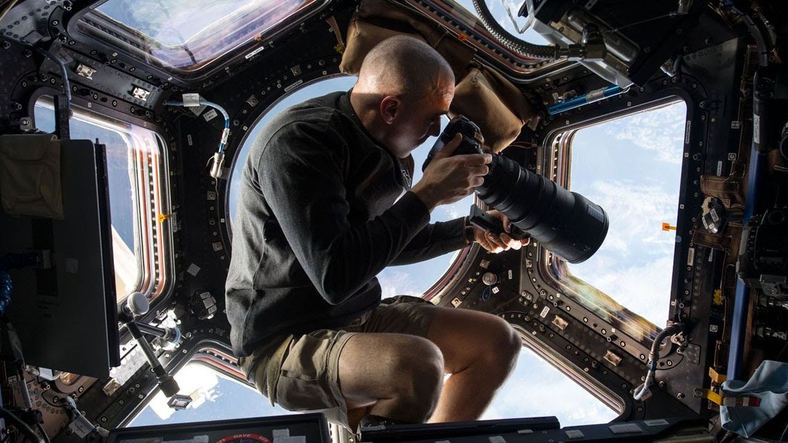 NASA astronaut Chris Cassidy uses a 400mm lens on a digital still camera to photograph the earth