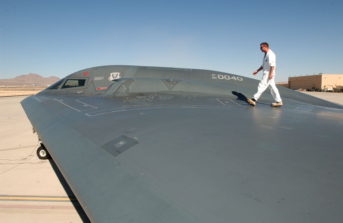 Sgt. Kevin Ponton examines the wing surface of a B-2 Spirit Bomber